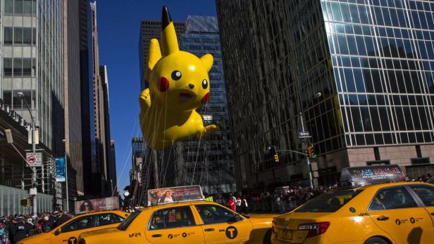 Ein Pikachu-Ballon schwebt über gelben Taxis in einer Straßenschlucht in New York.