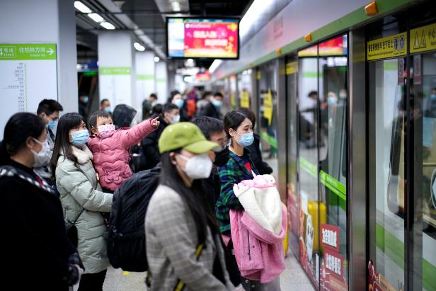 People wearing face masks wait for a subway train on the first day the city's subway services resumed following the novel coronavirus disease (COVID-19) outbreak in Wuhan