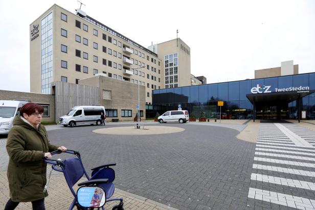 FILE PHOTO: A woman pushes a wheelchair in front of the ETZ hospital in Tilburg