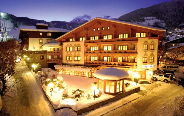 Der Tirolerhof, ein Hotel in den Bergen, ist im Winter mit Schnee bedeckt.