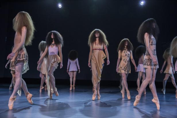 Eine Gruppe von Tänzerinnen in Kostümen auf einer Bühne.