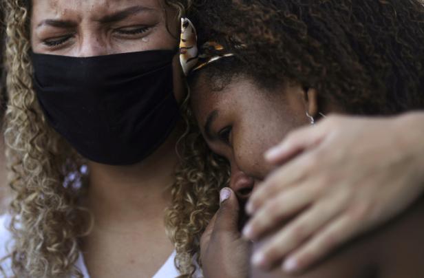 People mourn during the funeral of a teenager shot dead during a police operation against drug dealers in Salgueiro slum, Sao Goncalo
