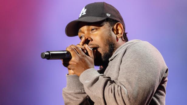 Kendrick Lamar rappt mit einem Mikrofon in der Hand.