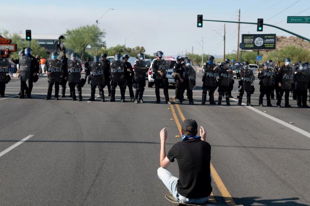 Police block protestors during the visit by U.S. President Donald Trump to the Dream City Church in Phoenix