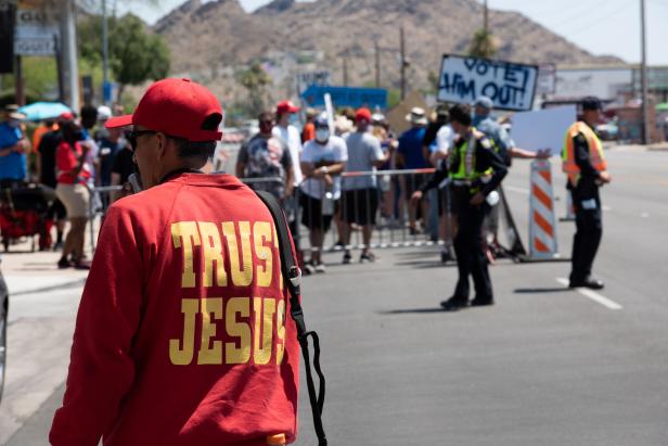 President Trump supporters rail against sin to a captive audience of protestors before the visit by U.S. President Donald Trump to the Dream City Church in Phoenix