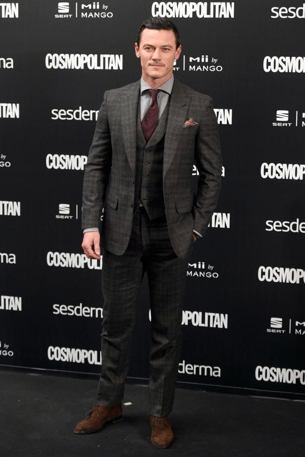Luke Evans in einem karierten Anzug auf einer Veranstaltung.