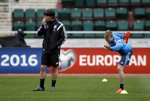 Germany's national soccer player Schuerrle and coach Loew attend a training session in Tbilisi