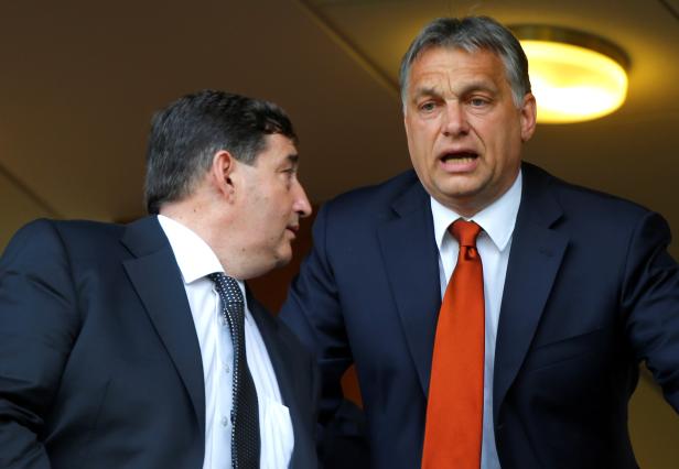 FILE PHOTO: Hungarian Prime Minister Viktor Orban is seen at a football match with his childhood friend Lorinc Meszaros in Felcsut