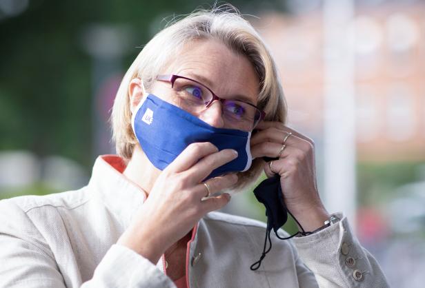 German minister for Education and Research Karliczek puts on a face mask during her visit to the Hamburg-Eppendorf university clinic in Hamburg