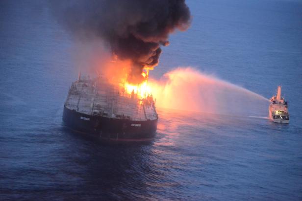  A Sri Lankan Navy boat sprays water on the New Diamond, a very large crude carrier (VLCC) chartered by Indian Oil Corp (IOC), that was carrying the equivalent of about 2 million barrels of oil, after a fire broke out off east coast of Sri Lanka