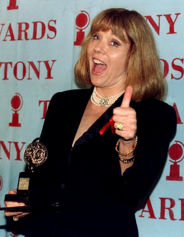FILE PHOTO: Diana Rigg gives the thumbs up sign as she holds her Tony Award for Best Performance by a Leading Ac..