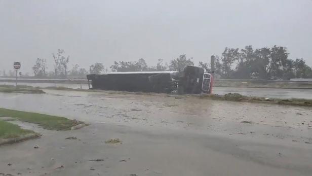 A truck flipped on its side due to winds from Hurricane Delta is seen at Lake Charles, Louisiana