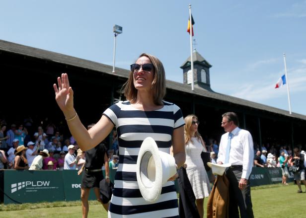 FILE PHOTO: Justine Henin of Belgium waves to the crowd after being inducted into the International Tennis Hall of Fame in Newport