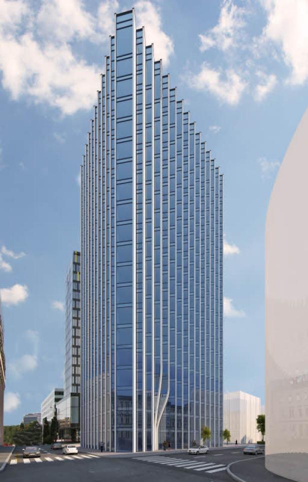 Ein modernes Hochhaus mit einer Fassade aus Glas und Stahl ragt in den Himmel.