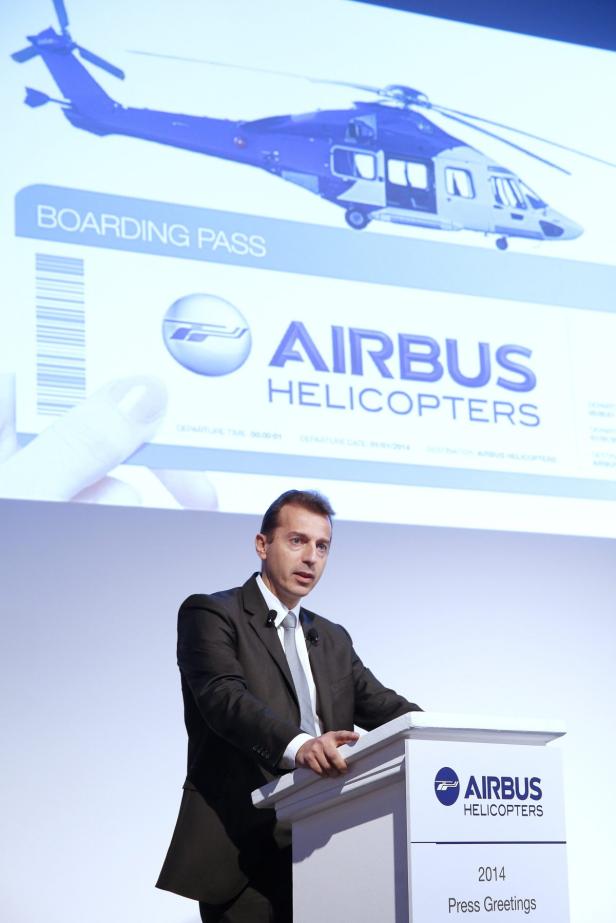 Ein Mann hält eine Präsentation über Airbus Helicopters vor dem Hintergrund eines Hubschrauberbildes.
