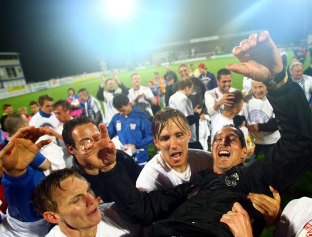 Eine Fußballmannschaft feiert ihren Sieg auf dem Spielfeld.
