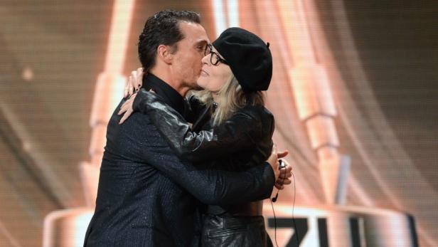 Matthew McConaughey umarmt und küsst Diane Keaton auf der Bühne.