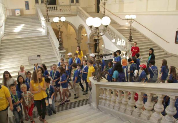 Eine Gruppe von Kindern steht auf einer Treppe in einem Gebäude.