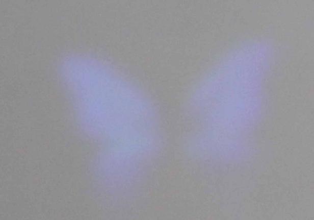 Abstrakte Darstellung von zwei blauen Farbflecken auf grauem Hintergrund.