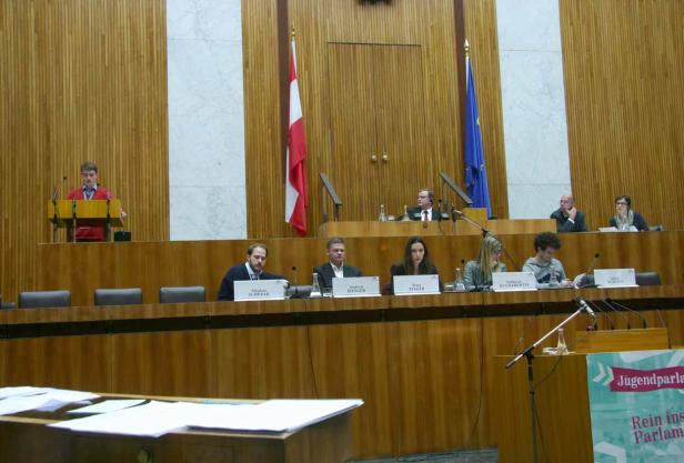 Eine Sitzung des Jugendparlaments in einem holzvertäfelten Saal.