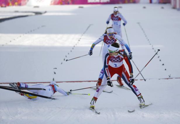 Eine Gruppe von Skilangläuferinnen bei einem Wettkampf, eine ist gestürzt.