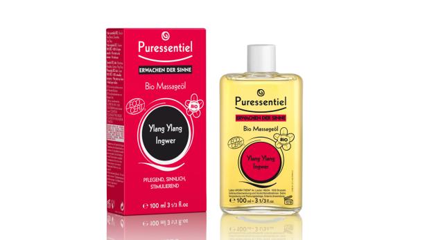 Eine Flasche und eine Verpackung des „Puressentiel Bio Massageöl Erwachen der Sinne Ylang Ylang Ingwer“.