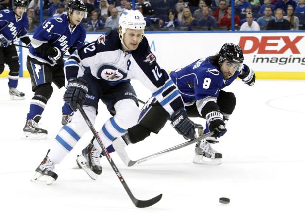 Zwei Eishockeyspieler kämpfen um den Puck auf dem Eis.