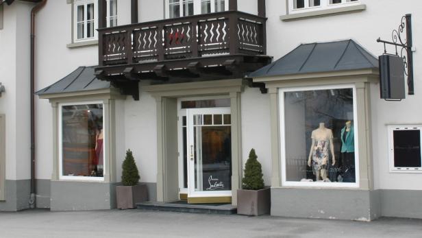 Die Fassade eines Christian Louboutin Geschäfts mit Schaufenstern und einem kleinen Balkon.