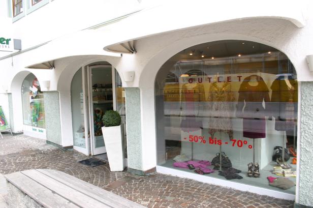 Ein Schaufenster eines Bekleidungsgeschäfts mit dem Hinweis „-50% bis -70%“.