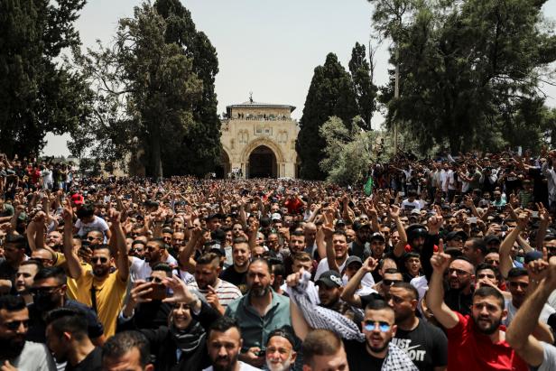 Palestinians shout slogans at the compound that houses Al-Aqsa Mosque in Jerusalem's Old City