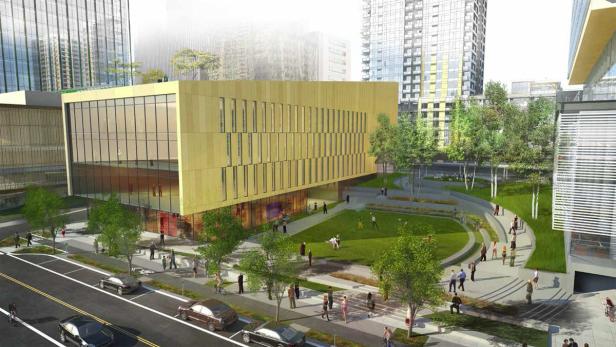 Eine moderne Stadtansicht mit einem markanten, goldenen Gebäude und umliegenden Grünflächen.