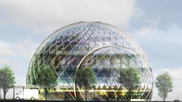 Ein großes, kuppelförmiges Gebäude mit einer Glasfassade und Bäumen davor.