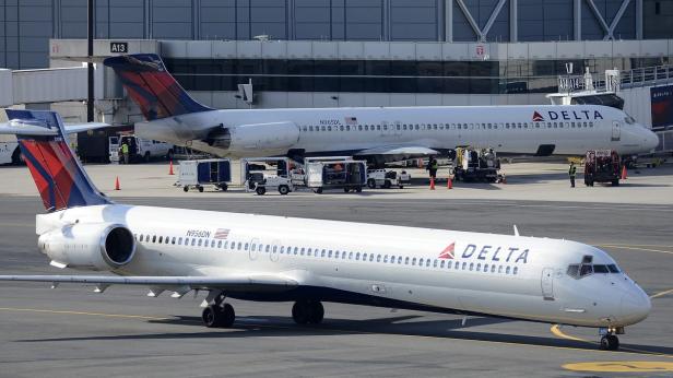 Zwei Flugzeuge der Fluggesellschaft Delta stehen auf einem Flughafen.