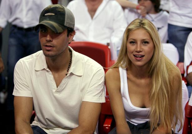 FILE PHOTO: Singer Enrique Iglesias (L) and tennis star Anna Kournikova of Russia watching the NBA Finals
