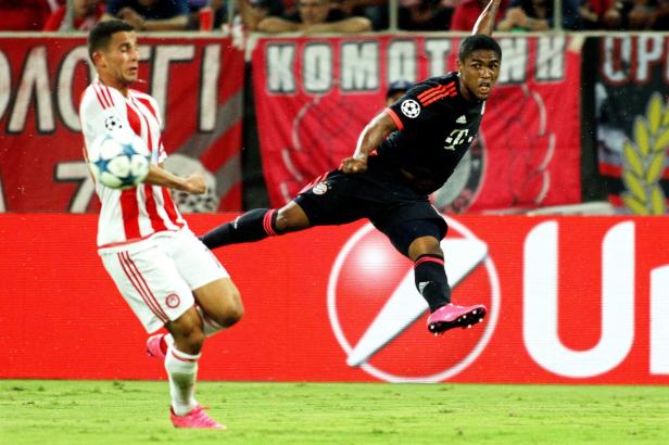 Zwei Fußballspieler während eines Spiels, einer in Rot und Weiß, der andere in Schwarz.