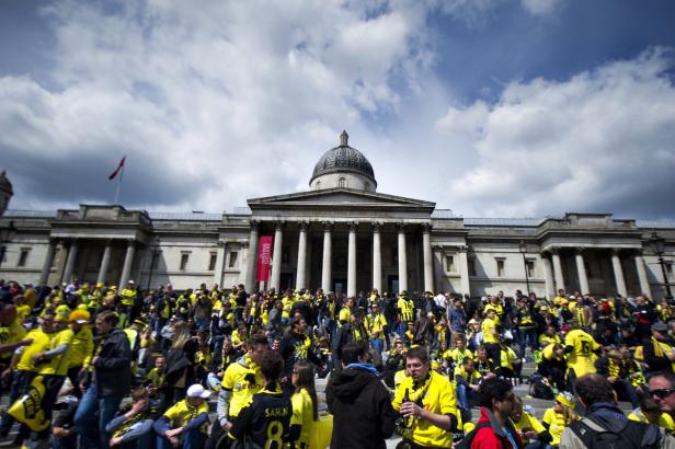 Eine Menschenmenge in gelben Trikots versammelt sich vor der National Gallery in London.