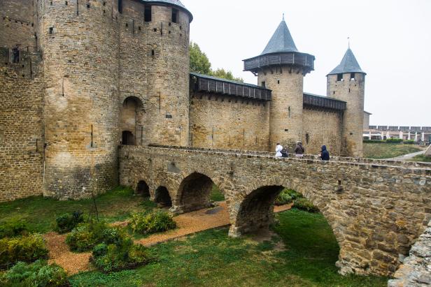Die mittelalterliche Festungsstadt Carcassonne mit einer Steinbrücke im Vordergrund.