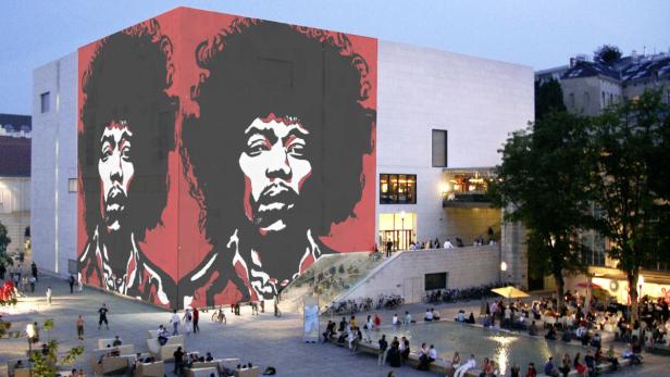 Ein großes Porträt von Jimi Hendrix an der Fassade eines Gebäudes, darunter ein belebter Platz.
