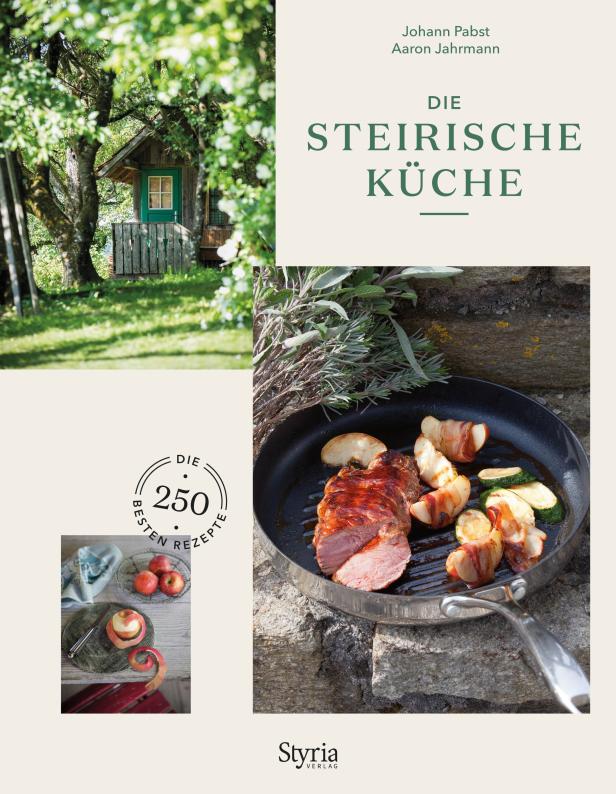 Das Cover des Kochbuchs „Die Steirische Küche“ mit einem Gericht aus Schweinefilet und Apfelspalten.