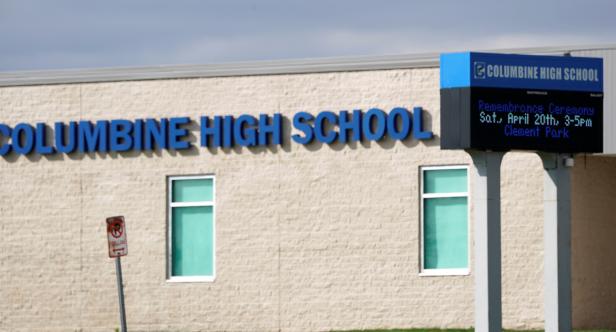 The digital sign outside Columbine High School refers to a memorial service as some Denver area schools have closed while police search for an armed woman in Littleton, Colorado