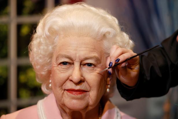 Artist Emma Meehan applies final touches on a new waxwork of the Queen