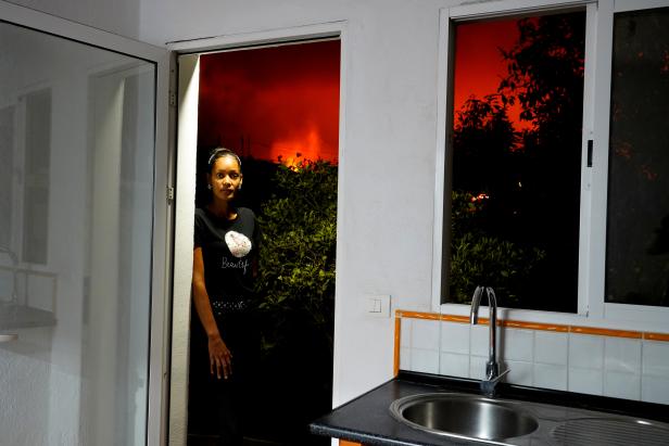 Jacqueline Peralta stands in a doorway in her home, from which lava can be seen in El Paso