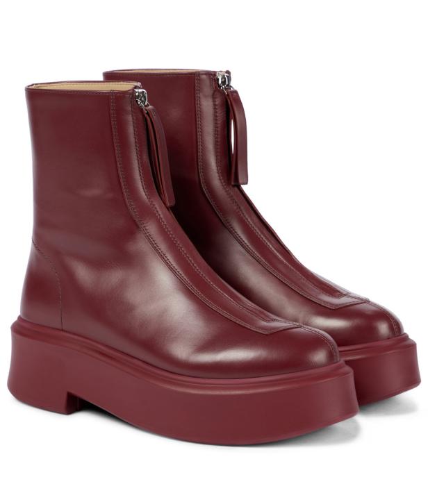 Ein Paar burgunderrote Stiefeletten mit Reißverschluss und Plateausohle.