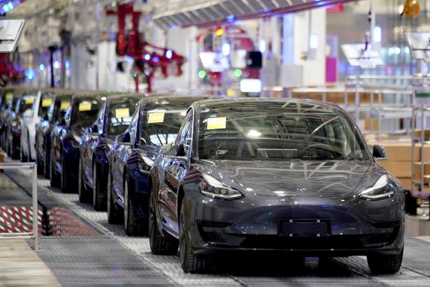 FILE PHOTO: Tesla China-made Model 3 vehicles are seen during a delivery event at its factory in Shanghai