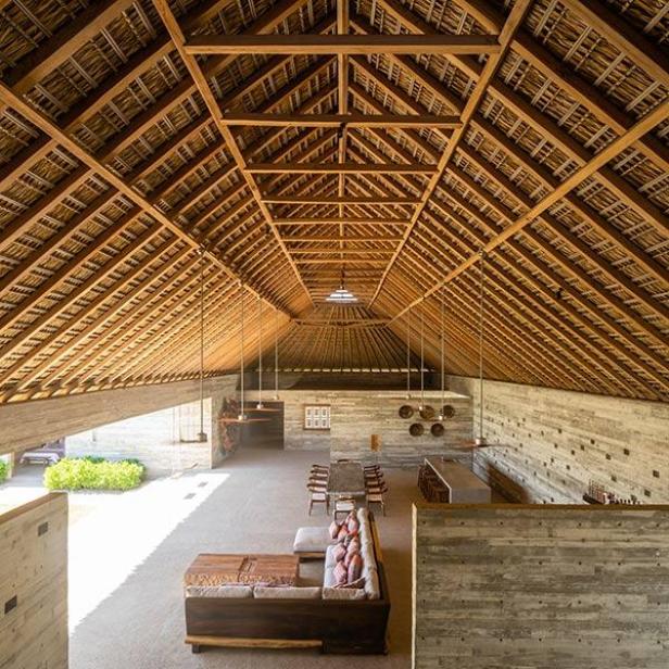 Innenansicht eines Hauses mit Palapa-Dach und Betonwänden.