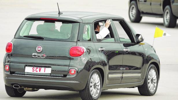 Ein schwarzer Fiat 500L mit dem Kennzeichen SCV 1 und der Flagge des Vatikans.