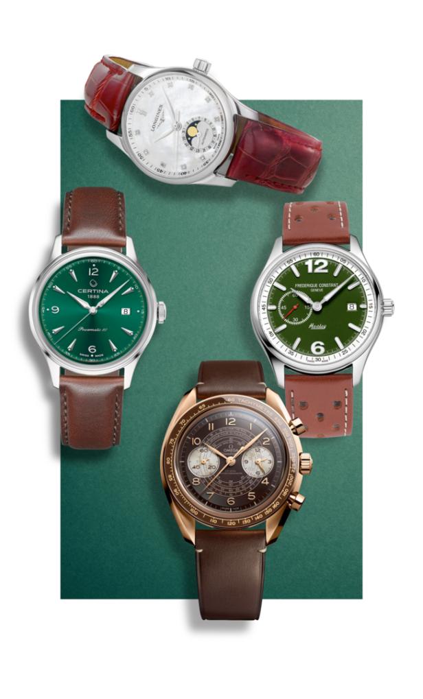 Eine Auswahl von vier Armbanduhren verschiedener Marken auf einem grünen Hintergrund.