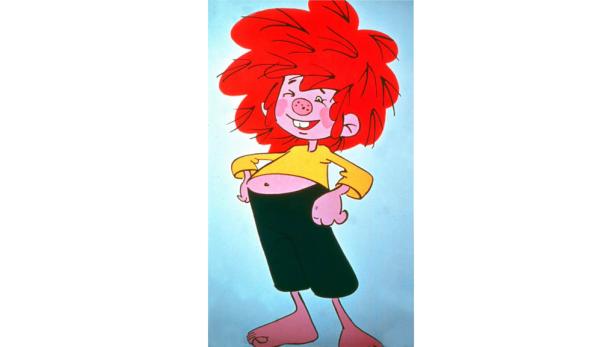 Ein frecher Pumuckl mit rotem Haar und gelbem Hemd steht barfuß da.