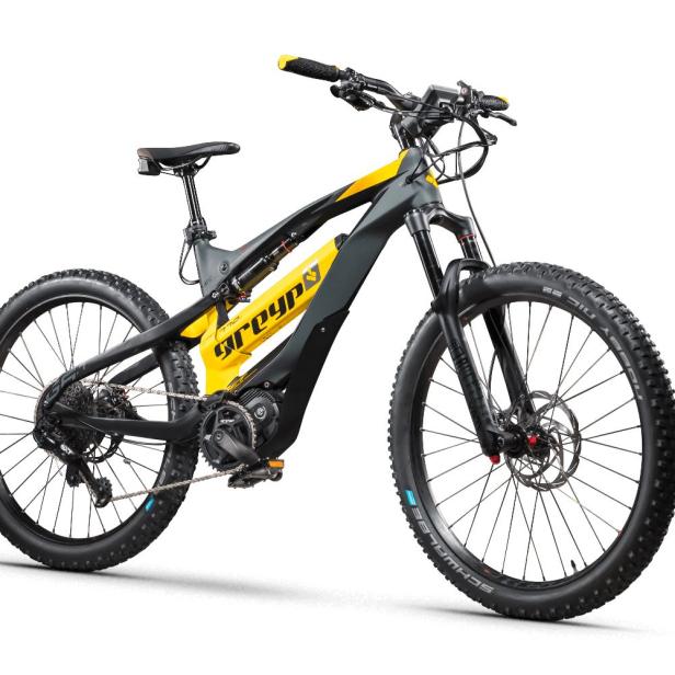 Ein gelb-schwarzes E-Mountainbike der Marke Greyp vor einem weißen Hintergrund.