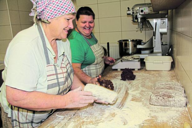 Zwei Frauen bereiten Teig in einer Bäckerei zu.